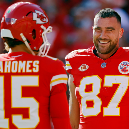 Travis Kelce #87 and Patrick Mahomes #15 of the Kansas City Chiefs talk before the game against the Los Angeles Chargers at GEHA Field at Arrowhead Stadium on October 22, 2023 in Kansas City, Missouri.