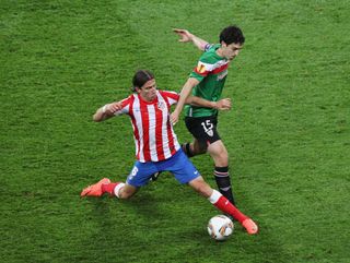 Filipe Luis of Atletico Madrid challenges Andoni Iraola of Athletic Bilbao during the UEFA Europa League Final between Atletico Madrid and Athletic Bilbao at the National Arena on May 9, 2012 in Bucharest, Romania.