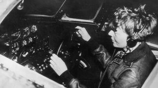 Amelia Earhart operates the controls of a flying laboratory, circa 1935.