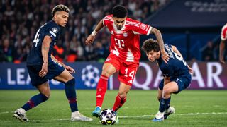 Luis Diaz of Bayern Munich dribbling past Desire Doue and Joao Neves of PSG in the UEFA Champions League 2025/26 Semi Final