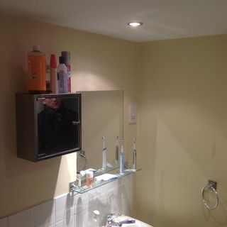 bathroom with cream wall and mirror