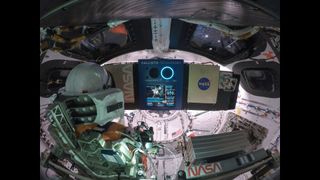 NASA's spacesuit-clad dummy Moonikin Campos rests inside the Orion spacecraft during the Artemis 1 lunar round-trip.