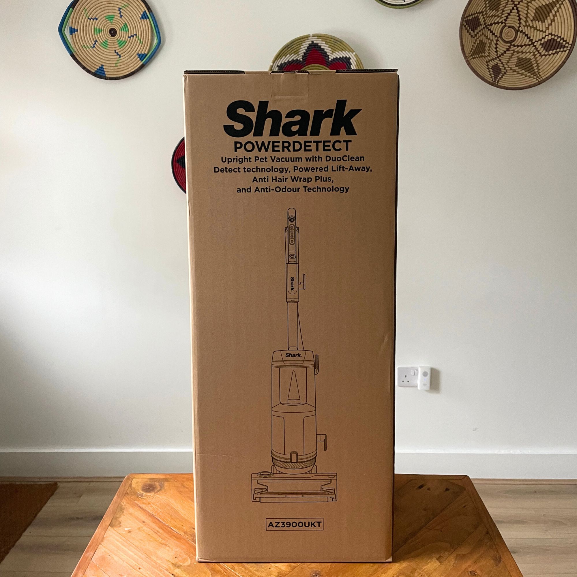 Shark PowerDetect Powered Lift-Away Upright Pet Vacuum Cleaner AZ3900UKT box sitting on a wooden table