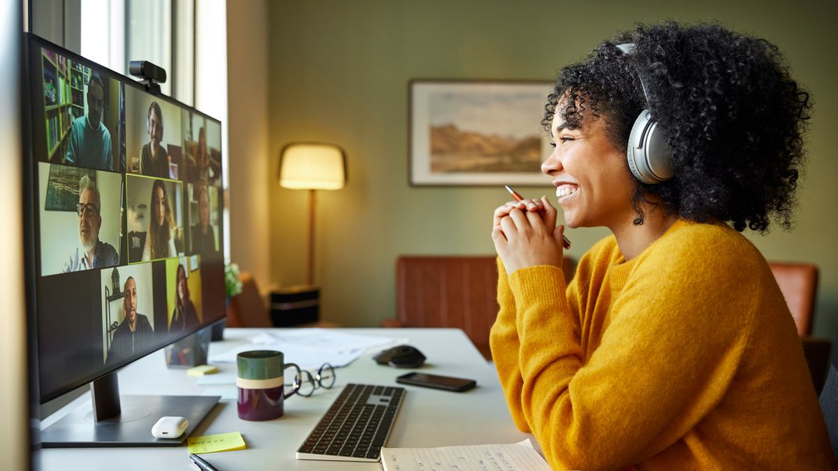 Woman sitting at desk conducting video call