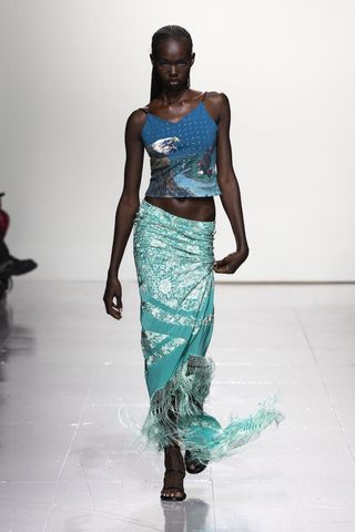 Woman on Conner Ives runway wearing skirt and top at London Fashion Week