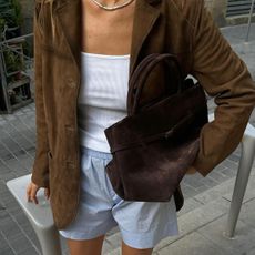 woman in suede jacket with bag