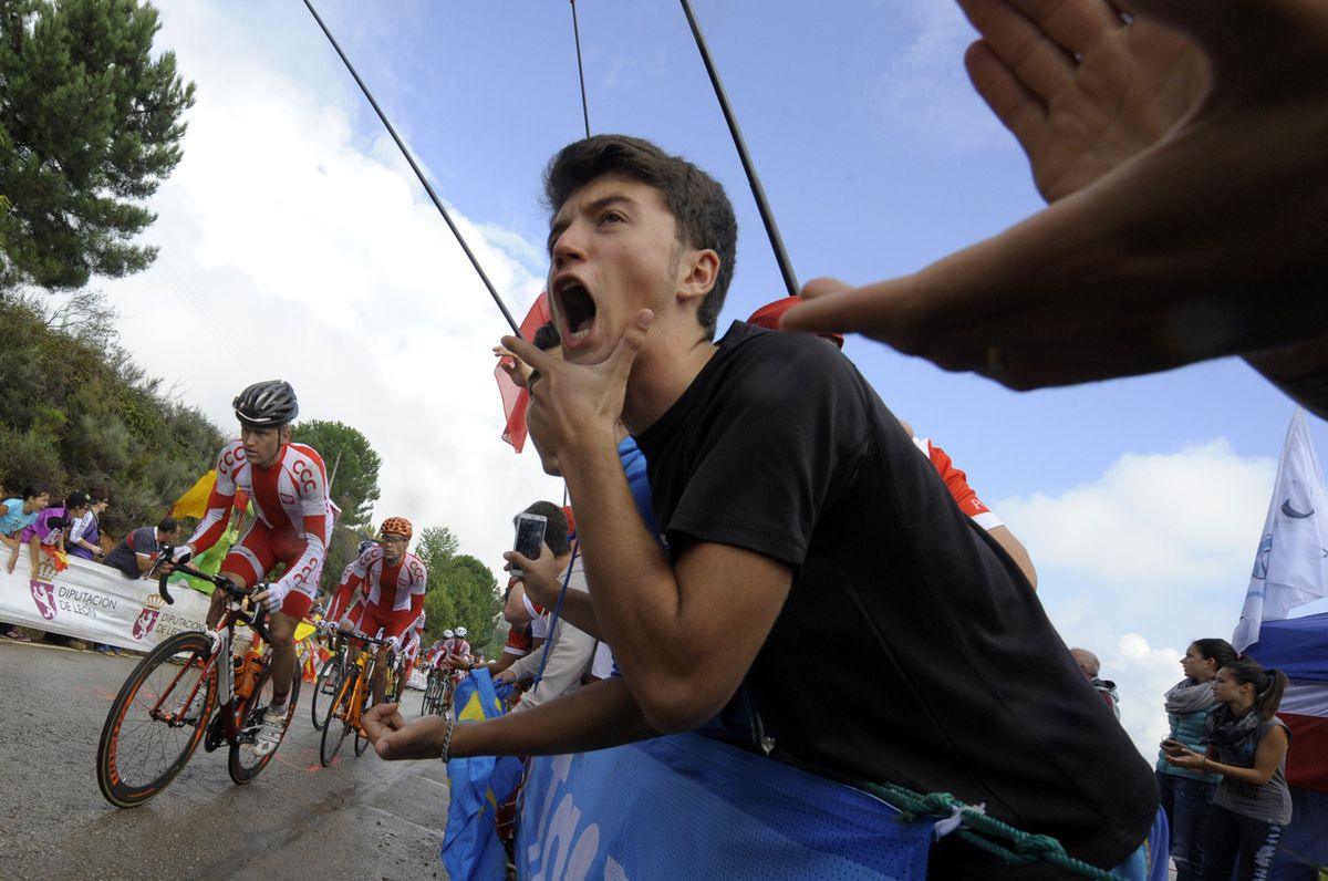 A fan cheers on the riders during the 2014 road race