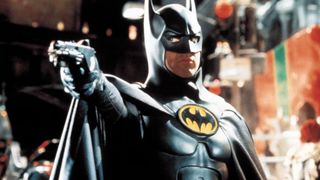 Michael Keaton as Batman pointing a gun during Batman Returns.