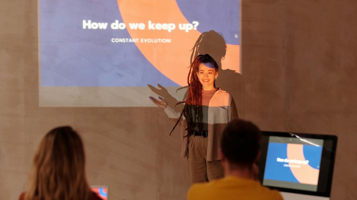 Woman giving presentation in front of projected slide