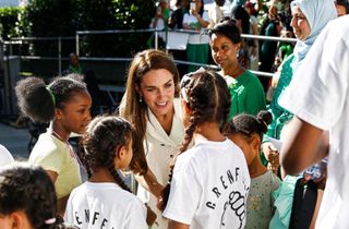Britain's Catherine, Duchess of Cambridge (C) speaks with survivors and bereaved children at a memorial service at the foot of Grenfell Tower in London, on June 14, 2022, the fifth anniversary of the Grenfell Tower fire where 72 people lost their lives. - The names of the 72 people who perished in Britain's worst residential fire since World War II were read out on June 14, 2022 at a church service marking the fifth anniversary of the blaze. Survivors and families of the victims of the Grenfell Tower fire gathered at Westminster Abbey for the first of a day of events to remember the tragedy.