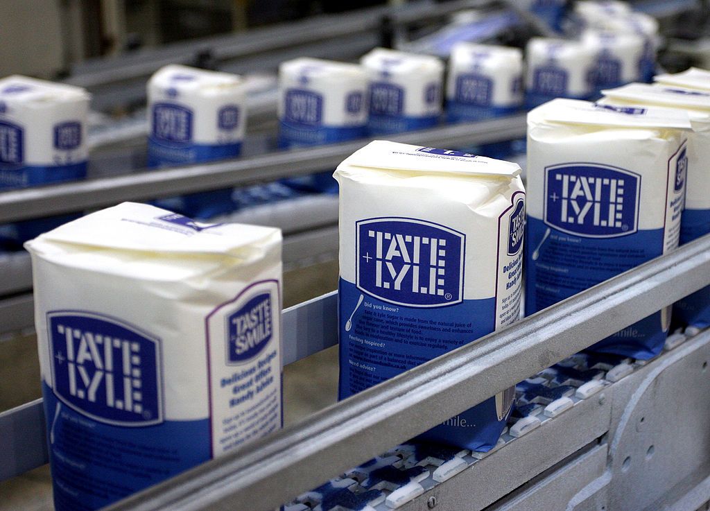 Packs of Tate &amp; Lyle granulated sugar pass along the production line