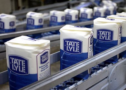 Packs of Tate & Lyle granulated sugar pass along the production line