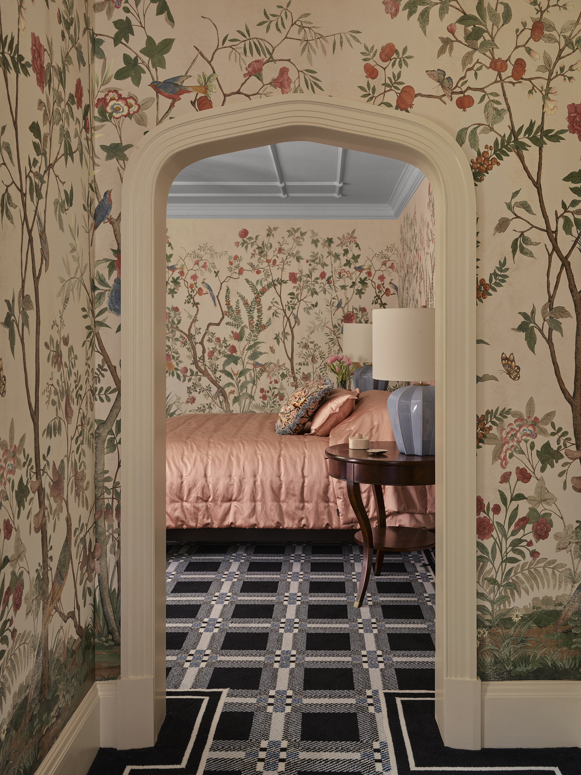 a traditional style bedroom with botanical wallpaper