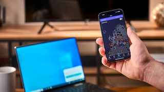 Proton VPN on a phone in front of a PC