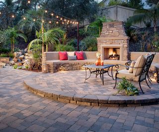 brick paved split level patio with outdoor fireplace
