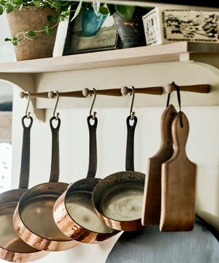 Pots and pans on wooden hooks