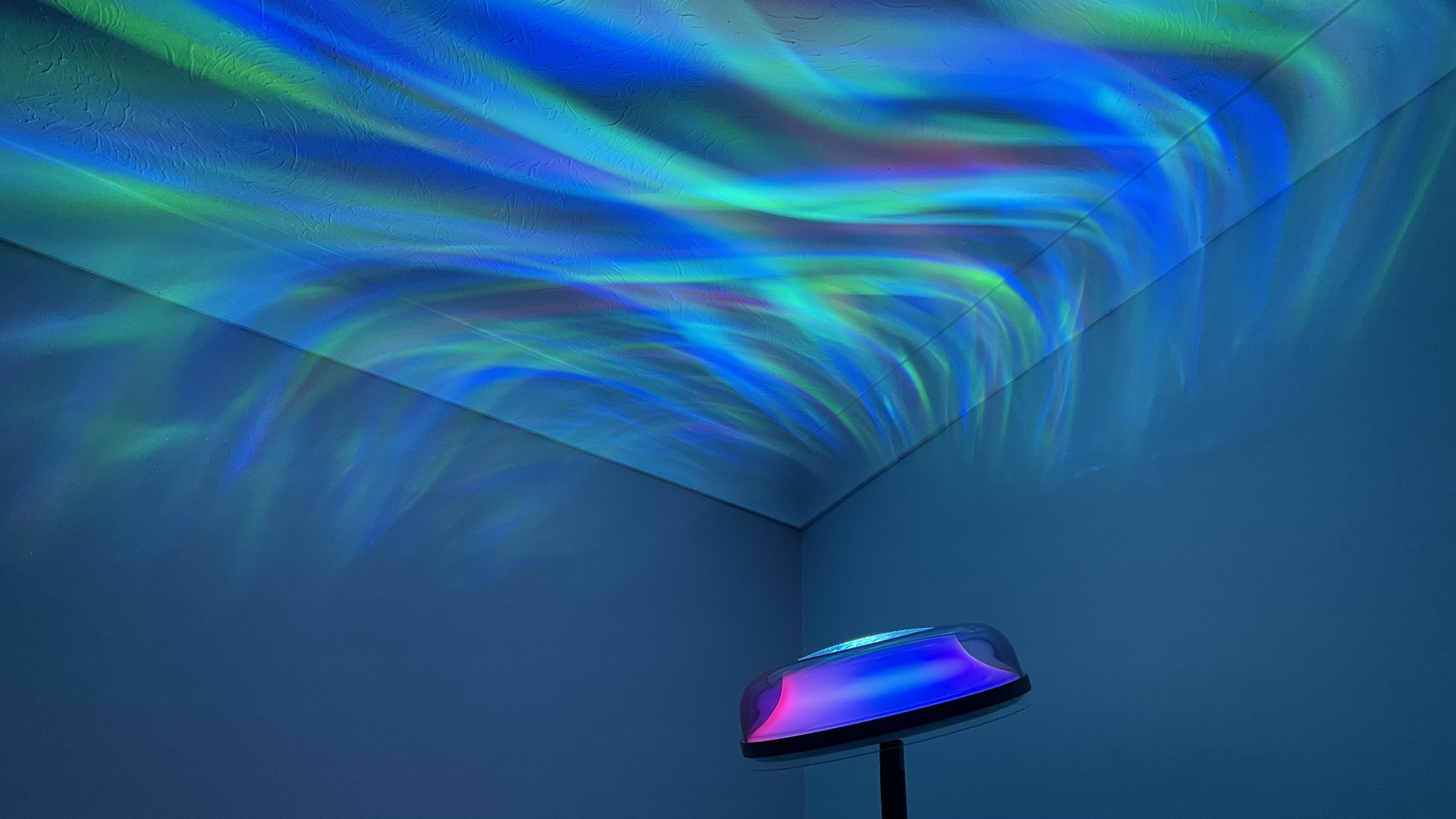 The Govee Uplighter is projecting multicolored ripples of light onto the ceiling.