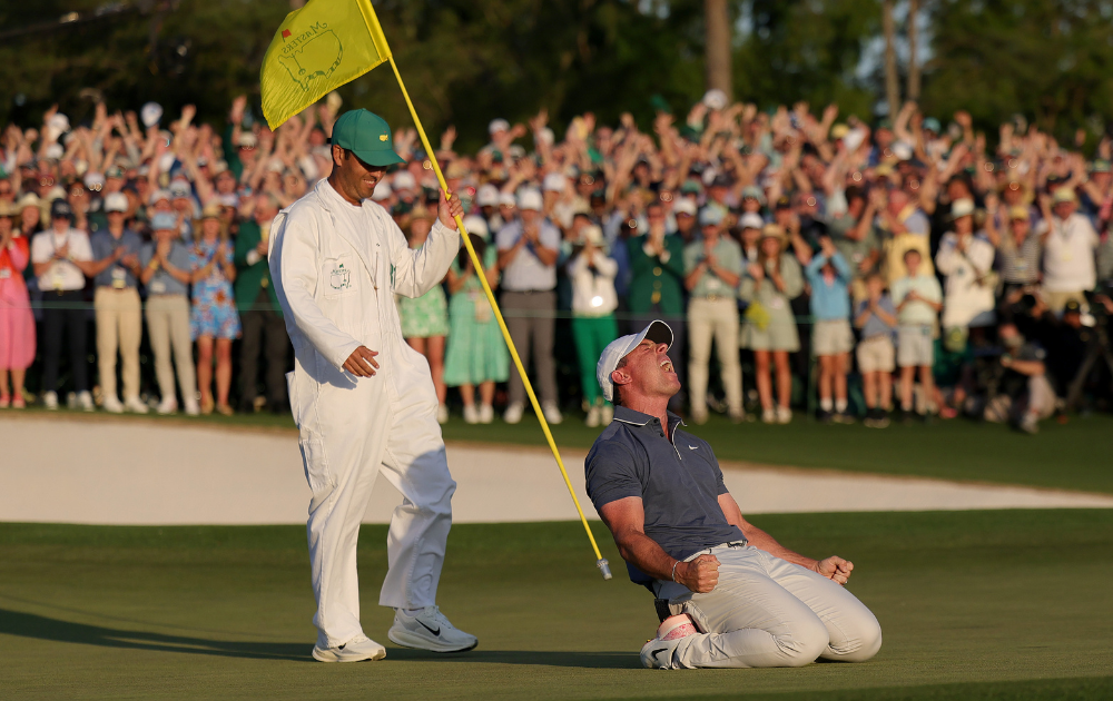Rory McIlroy of Northern Ireland celebrates winning with caddie Harry Diamond after the playoff hole during the final round of the 2025 Masters Tournament at Augusta National Golf Club on April 13, 2025 in Augusta, Georgia