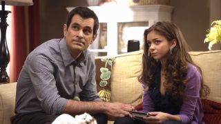 phil teaching haley how to work the remote on modern family.