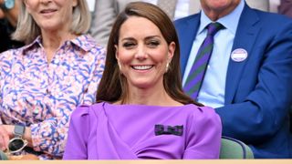 Catherine, Princess of Wales laughing court-side of Centre Court during the men's final on day fourteen of the Wimbledon Tennis Championships 2024