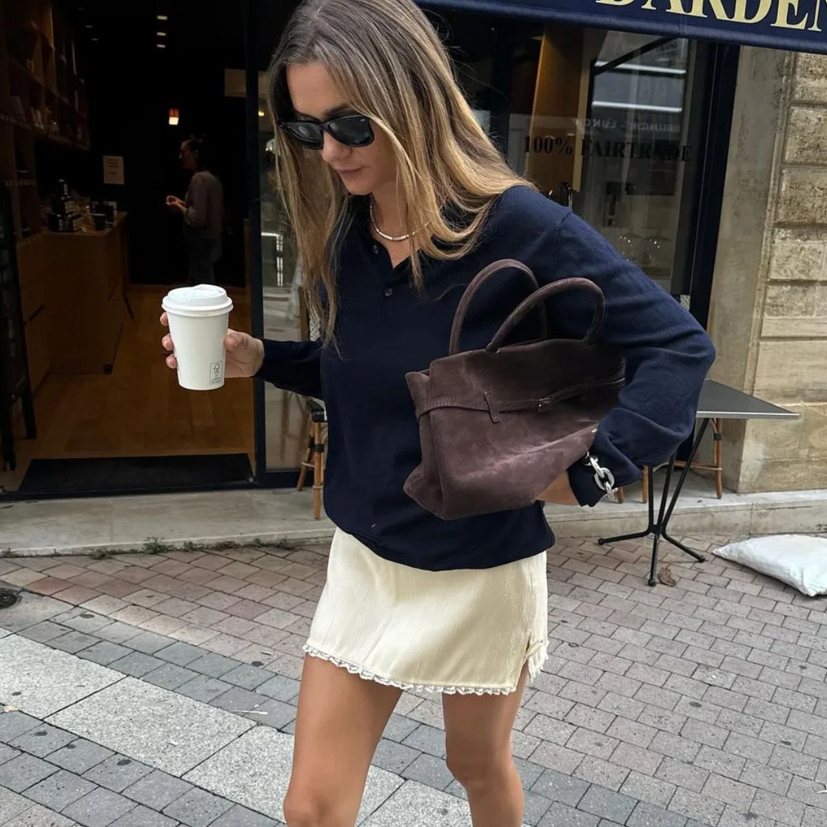 @annelauremais wears a navy jumper and butter yellow dress, one of the best autumn fashion colour combinations.