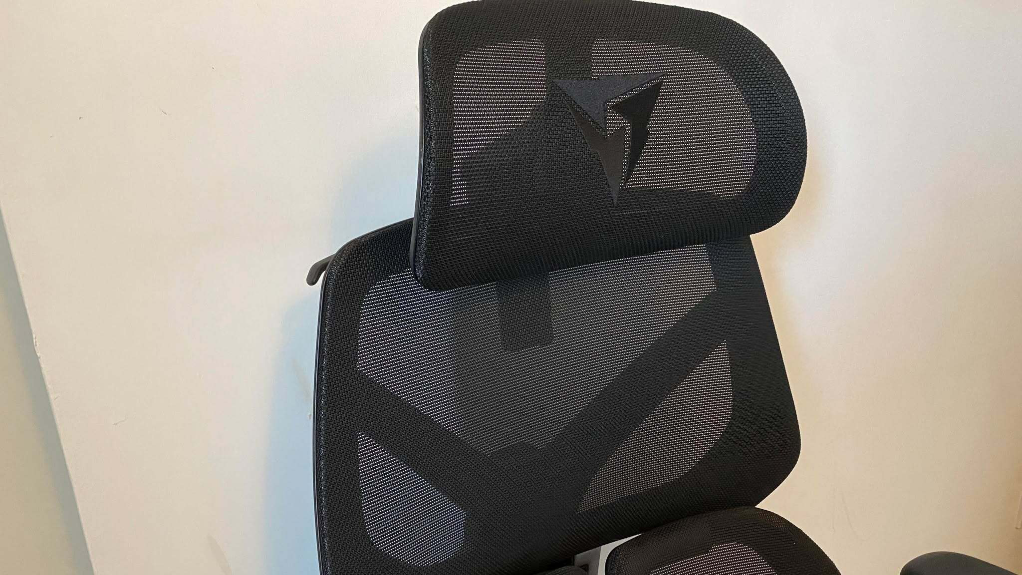 ThunderX3 chair set up in front of a white wall.
