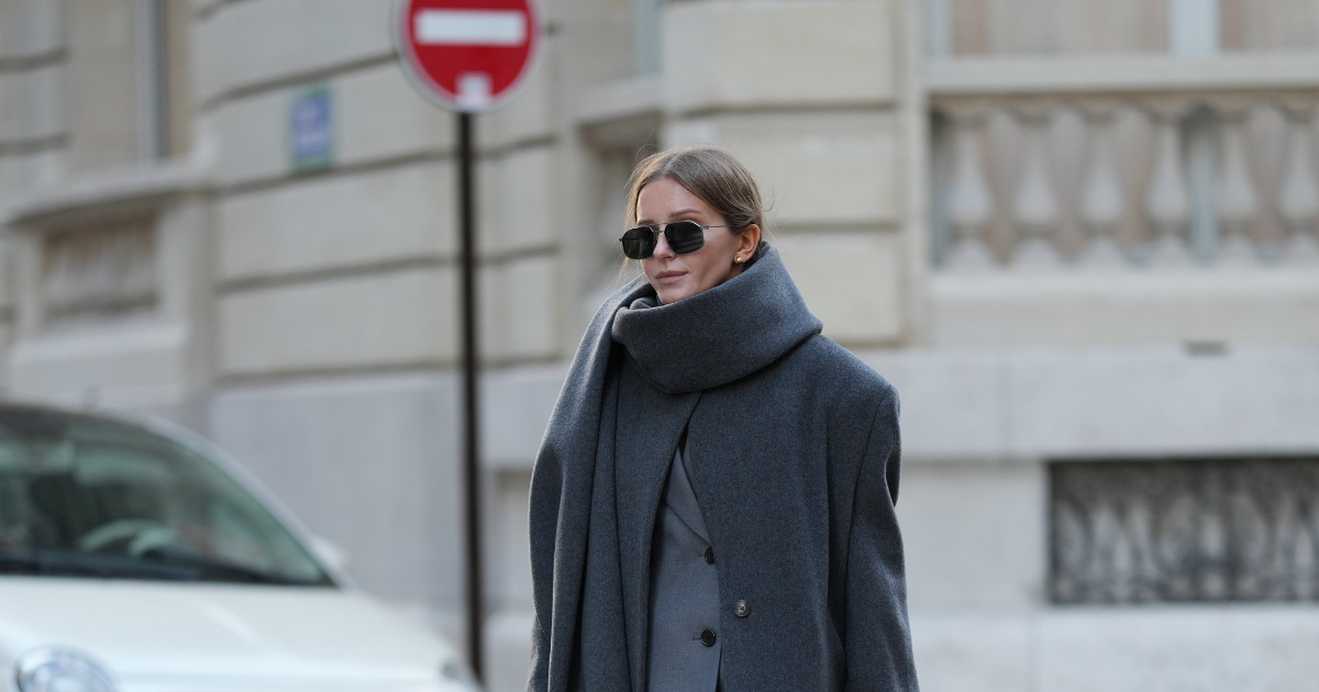 Best Gel Moisturisers Diane Batoukina wears a long grey wool coat and matching scarf by By Aylin Koenig layered over a tailored light grey wool suit by The Frankie Shop