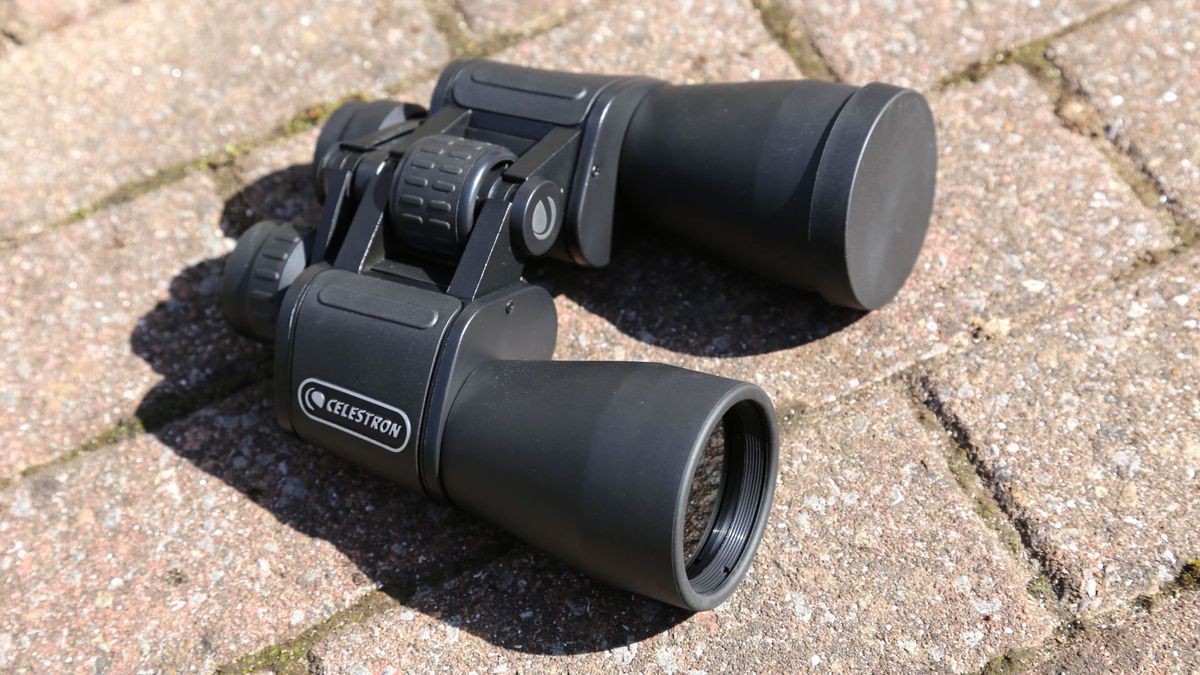 EclipSmart 12x50 binoculars placed on a stone surface