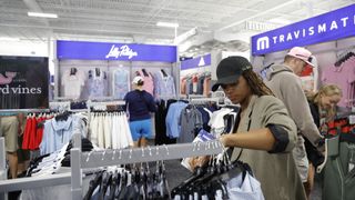 Woman browsing golf clothing at PGA TOUR superstore