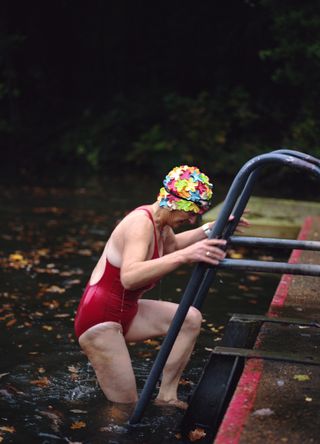 Woman wild swimming in a pond