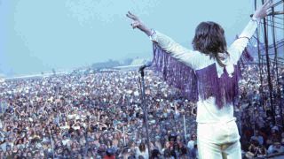 Black Sabbath’s Ozzy Osbourne standing onstage in front of thousands of people at a festival