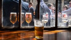 Pints of Madri lager seen through a pub window