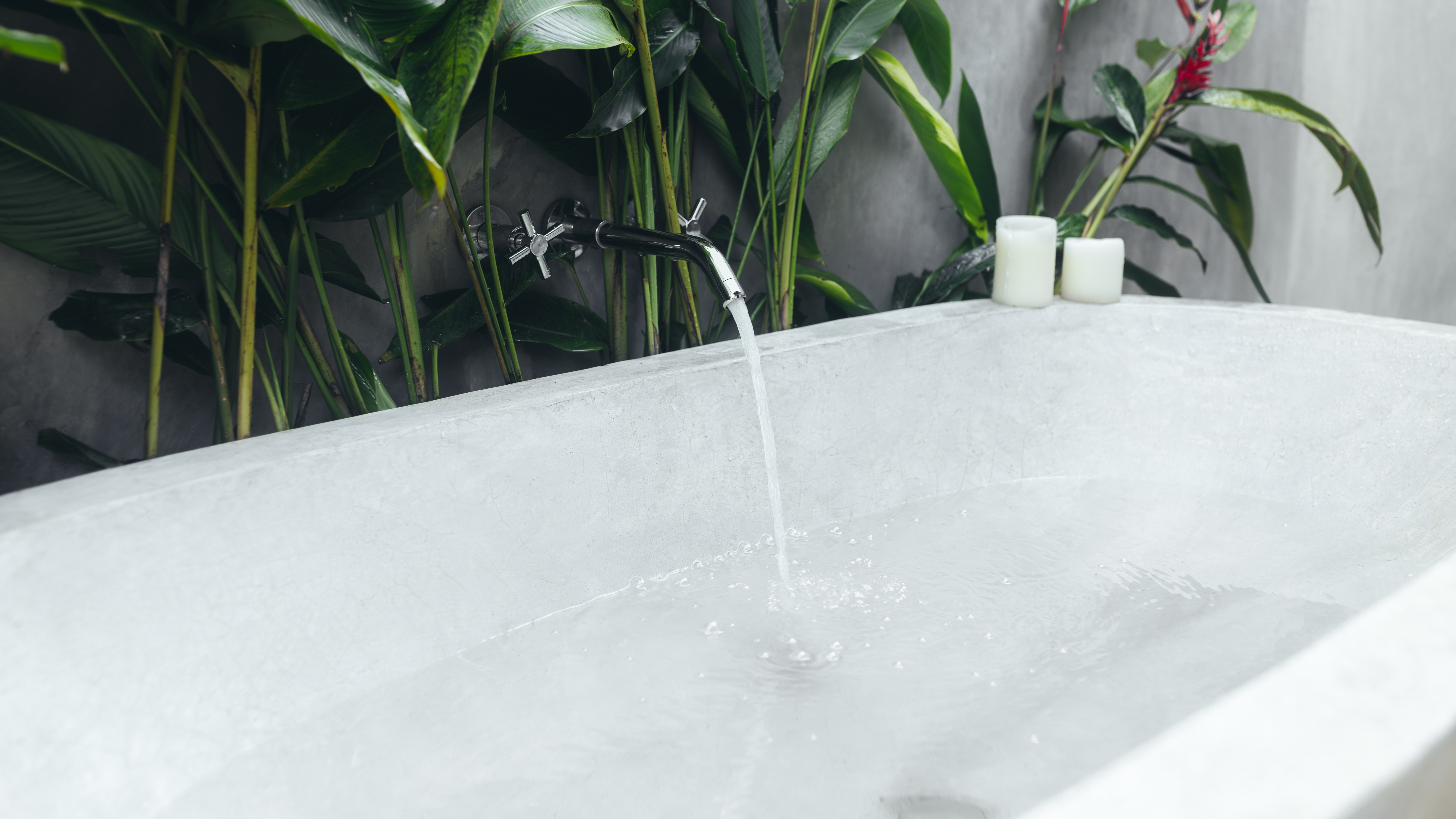 Running tap filling bathtub with water