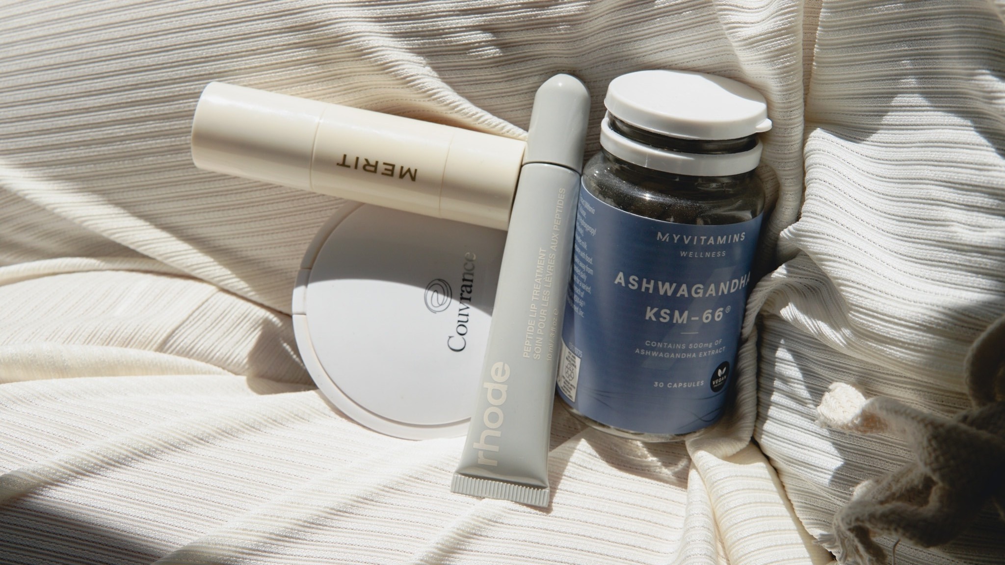 Photo of skincare products on a bed
