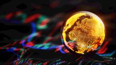 A gold globe showing Europe and Africa sits on top of a stock chart
