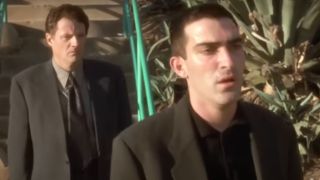 Two men walking behind a diner in Mulholland Drive