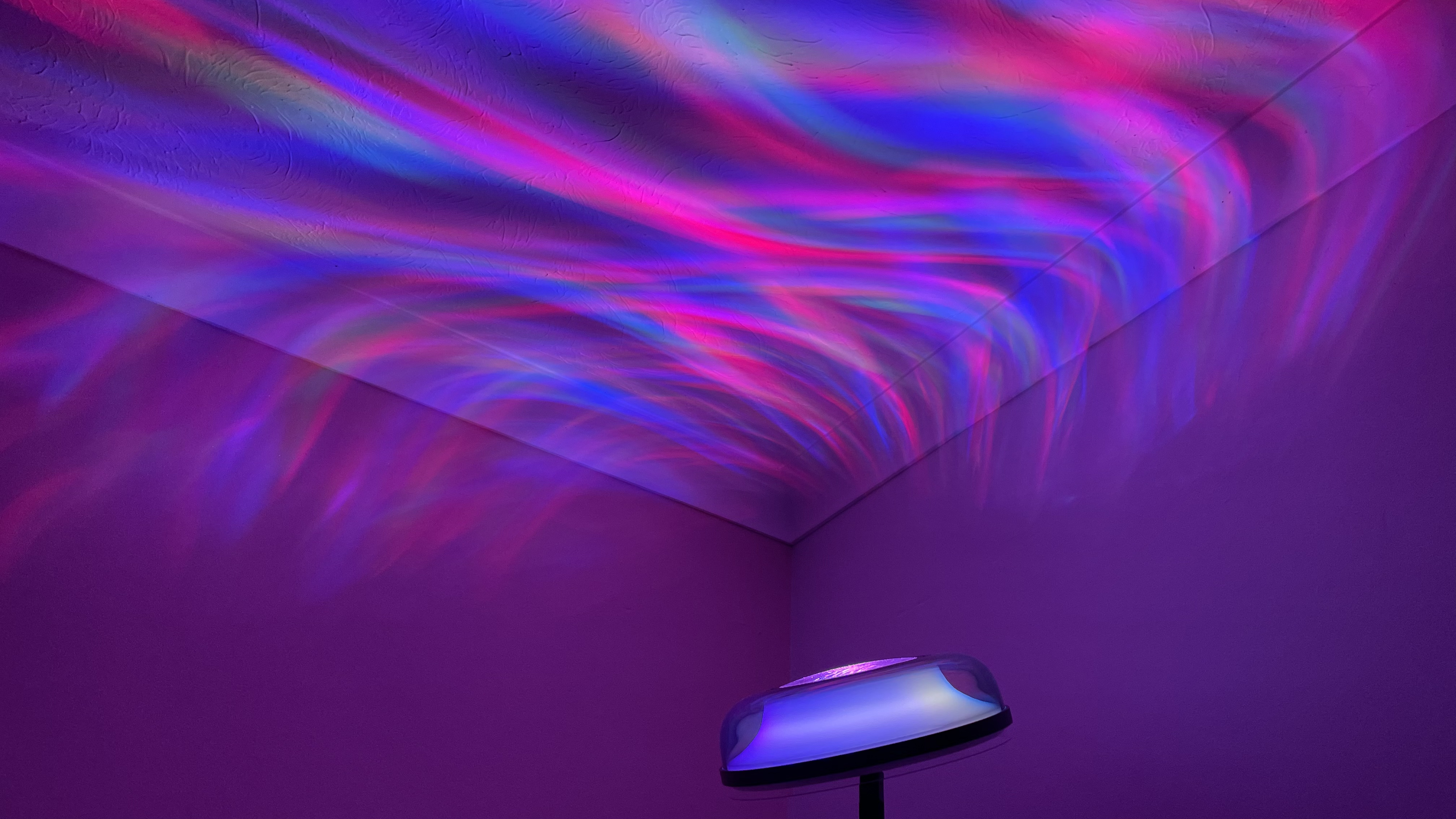 The Govee Uplighter is projecting multicolored ripples of light onto the ceiling.