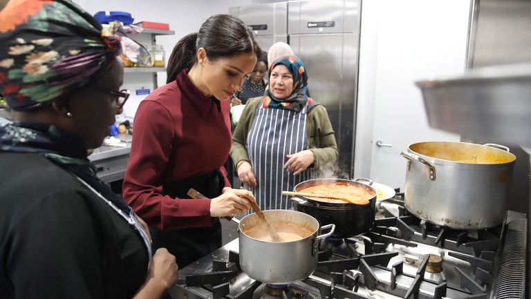 london, england november 21 meghan, duchess of sussex with chef clare smyth r and kitchen co ordinator zaheera sufyaan 2l as she visits the hubb community kitchen to see how funds raised by the together our community cookbook are making a difference at al manaar, north kensington on november 21, 2018 in london, england photo by chris jacksongetty images
