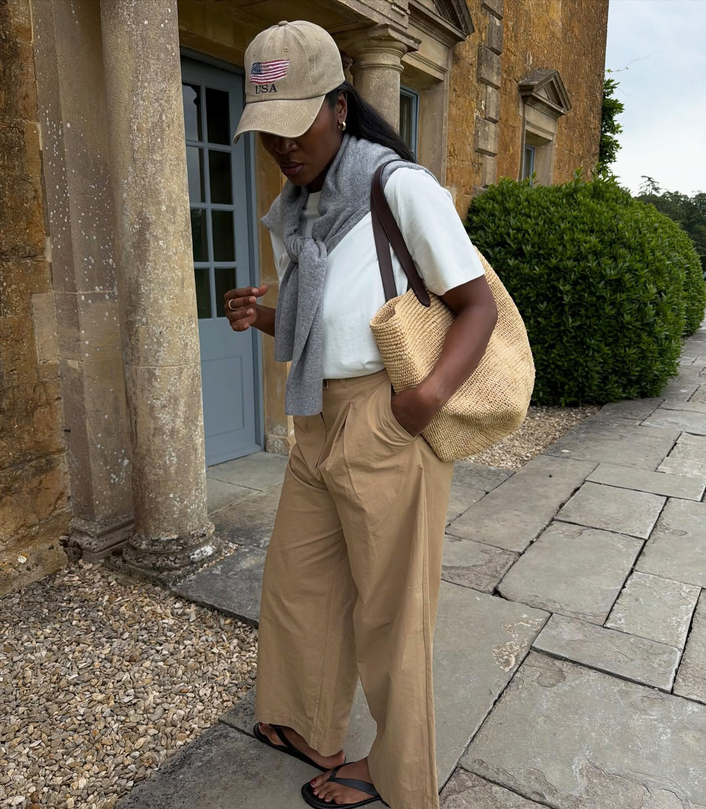 Influencer wearing summer 2026's raffia tote trend