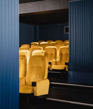Interior view of a screen at Yorck Kino Passage cinema featuring blue walls and yellow seats