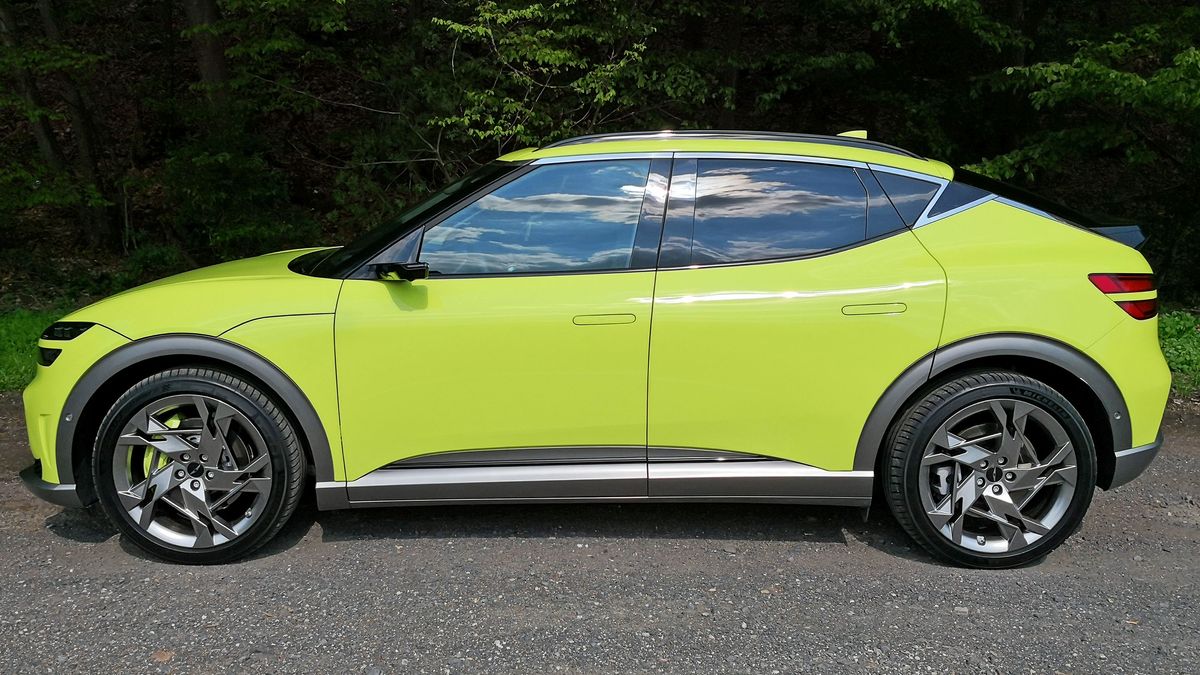 Side view of green GV60 parked at side of road