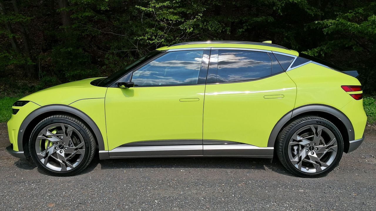 Side view of green GV60 parked at side of road