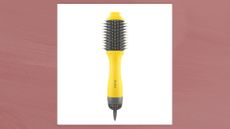 Image of the Drybar The Double Shot Blow Dryer Brush in a white box against a dark pink watercolour background