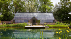 beautiful large greenhouse positioned across from a moat