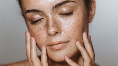 Best cleanser: Woman with clear skin looking over shoulder