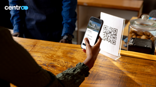 The Centro app scans a QR code from a phone.