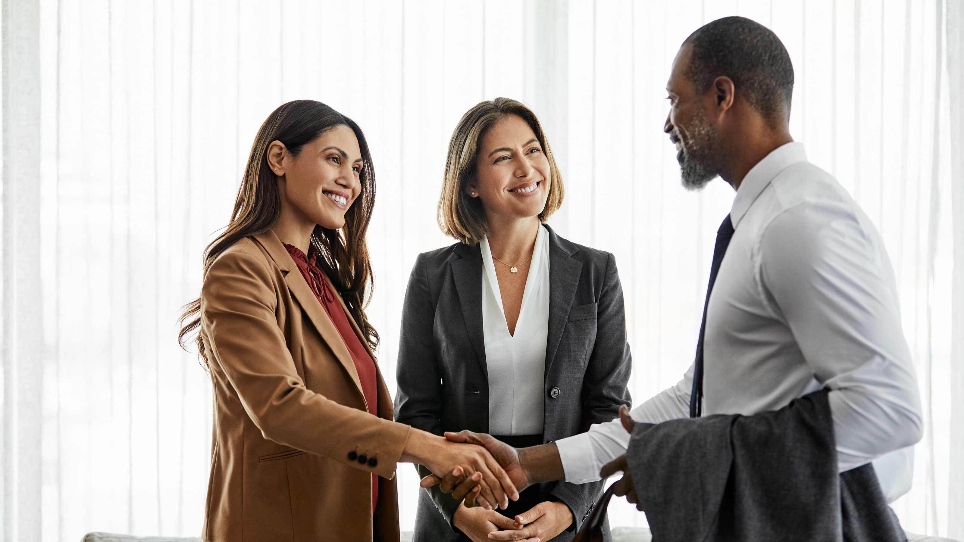 Two financial advisers meet with a high-net-worth client.