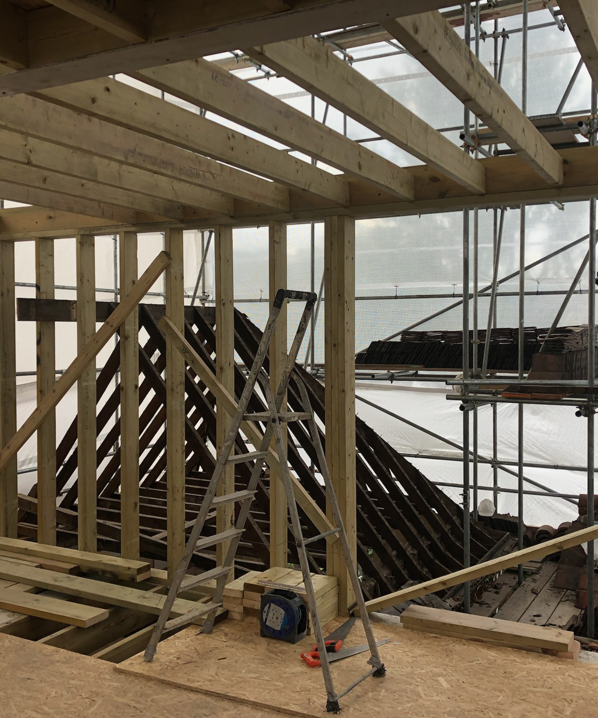 A loft extension with beams and chipboard flooring