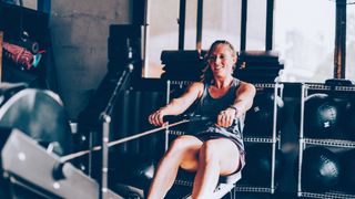 Woman using rowing machine in gym
