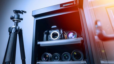 dry cabinet full of camera equipment and lenses